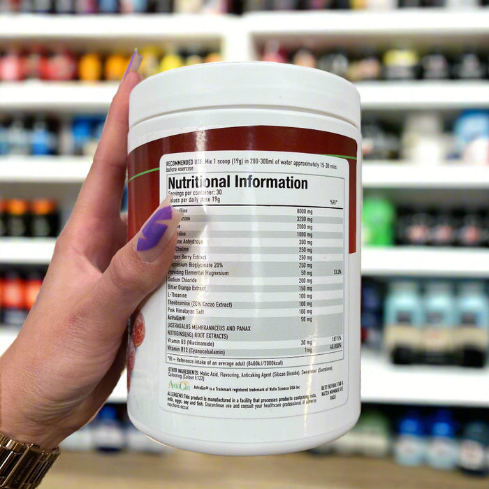 Close-up of (Per4m Pre Workout Stim 570g 30 Servings) held up inside My Supplement Shop, clearly showing Nutritional Values on the packaging in a Sports Nutrition setting.
