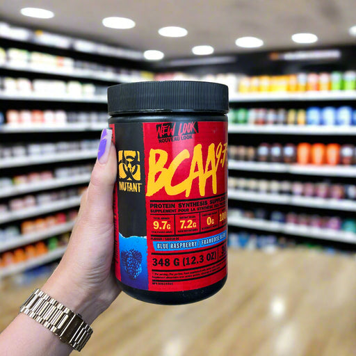 Close-up of (Mutant BCAA 9.7 with Micronized Amino Acid and Electrolyte Support Stack) held up inside My Supplement Shop, clearly showing the front label in a Sports Nutrition setting.